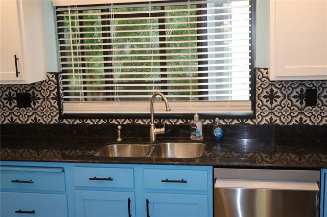 a kitchen with a sink and cabinets