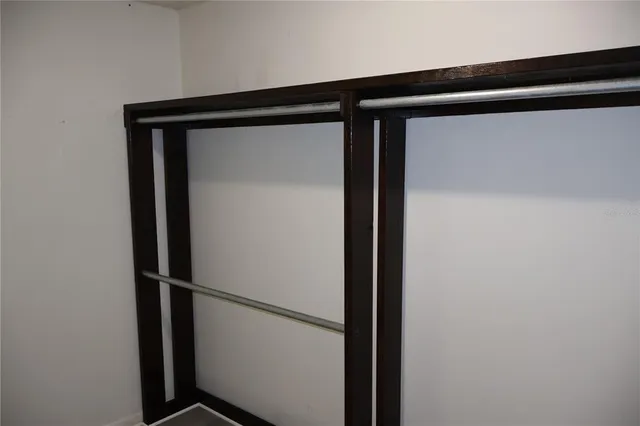 a view of a room with wooden floor and a potted plant