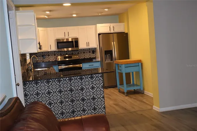 a kitchen with a refrigerator and a stove