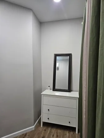 a room with a mirror and a wooden door