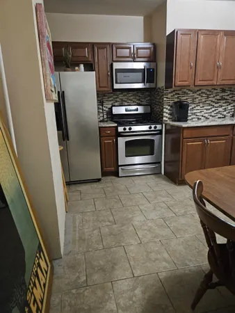 a kitchen with stainless steel appliances a stove a microwave and a refrigerator