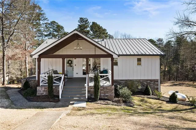 a front view of a house with yard outdoor seating and barbeque oven