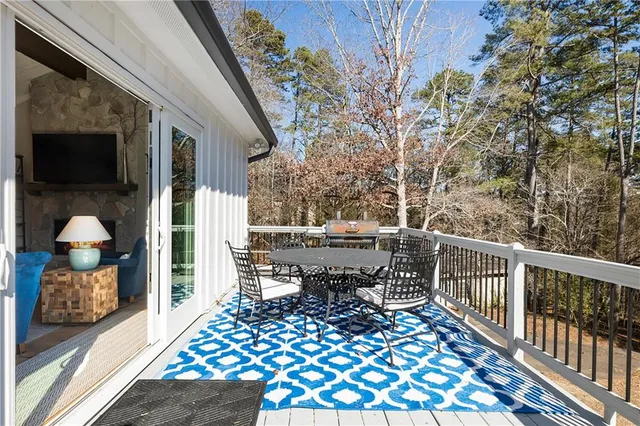 a view of a balcony with wooden floor and fence
