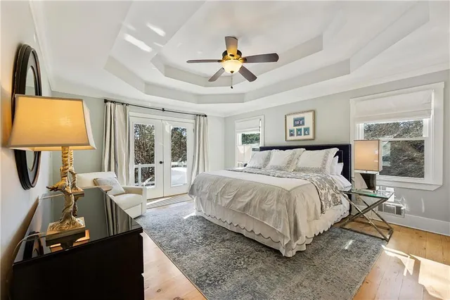 a spacious bedroom with a bed and ceiling fan