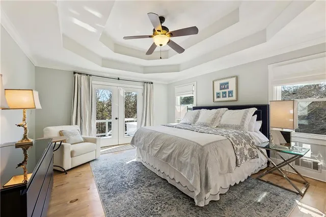 a bedroom with a large bed and a chandelier