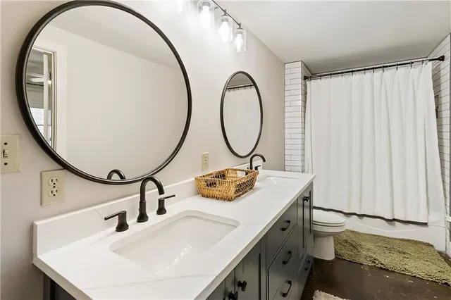 a bedroom with a bed a couch and dresser