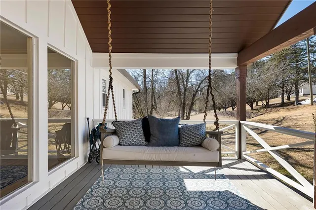 a view of a two chairs in the patio of a house