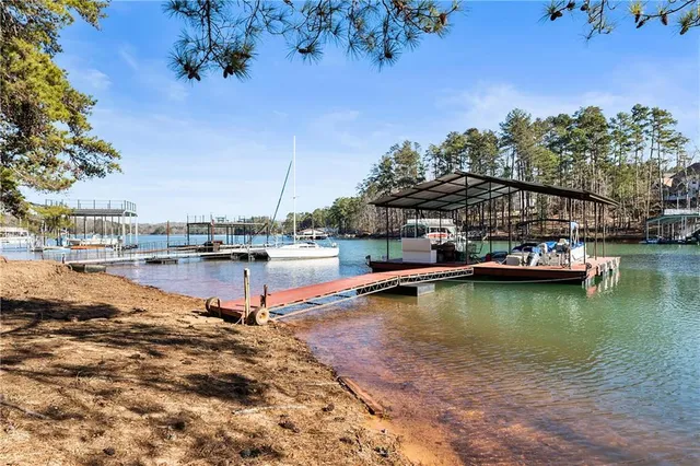 an aerial view of a house with a garden and lake view