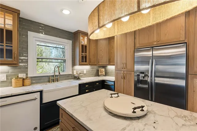 a kitchen with a sink a refrigerator and cabinets