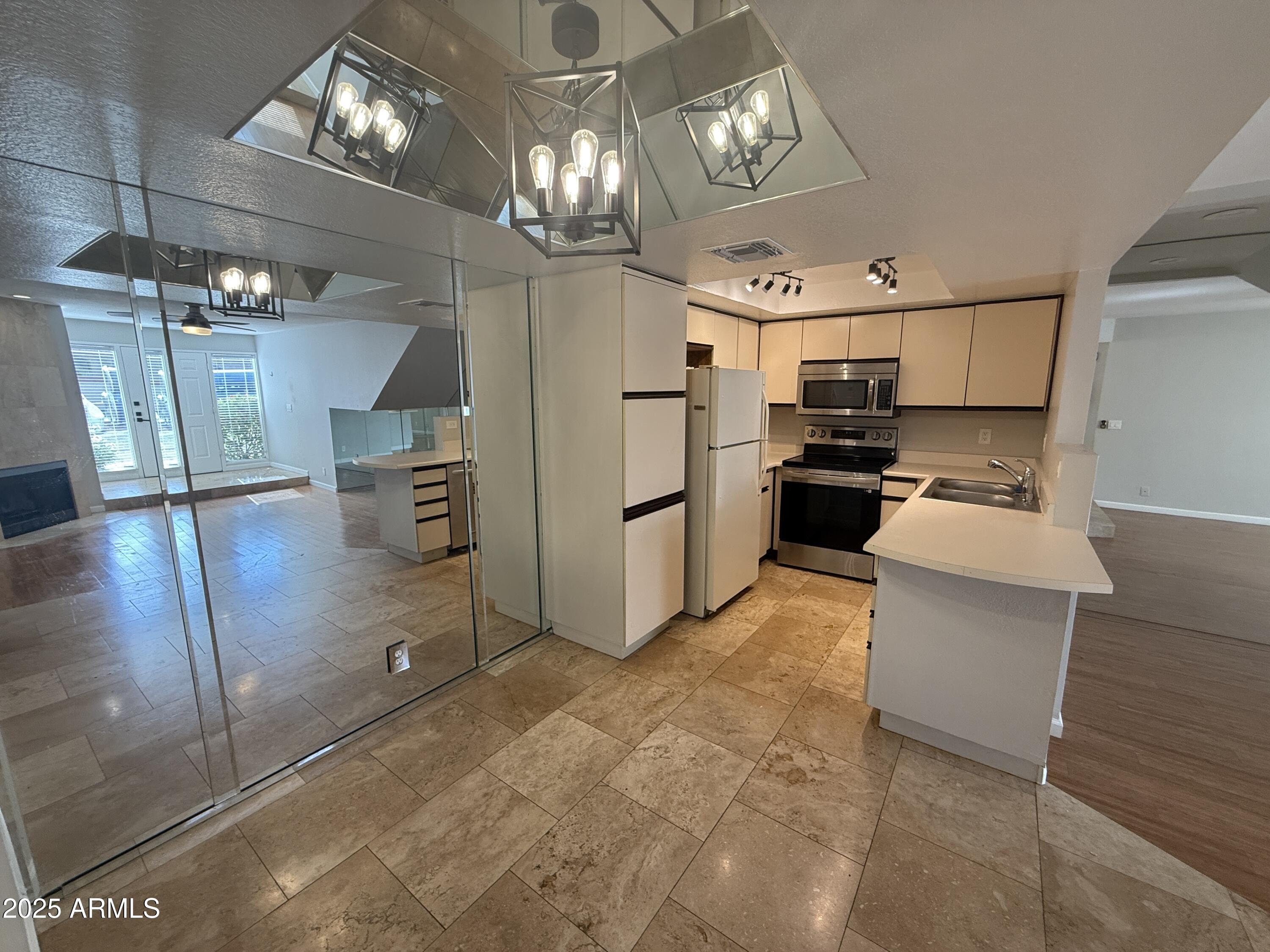 1820 East Morten Avenue, Unit 125 Phoenix, AZ 85020 - Photo 11 of 21 a kitchen with refrigerator and cabinets