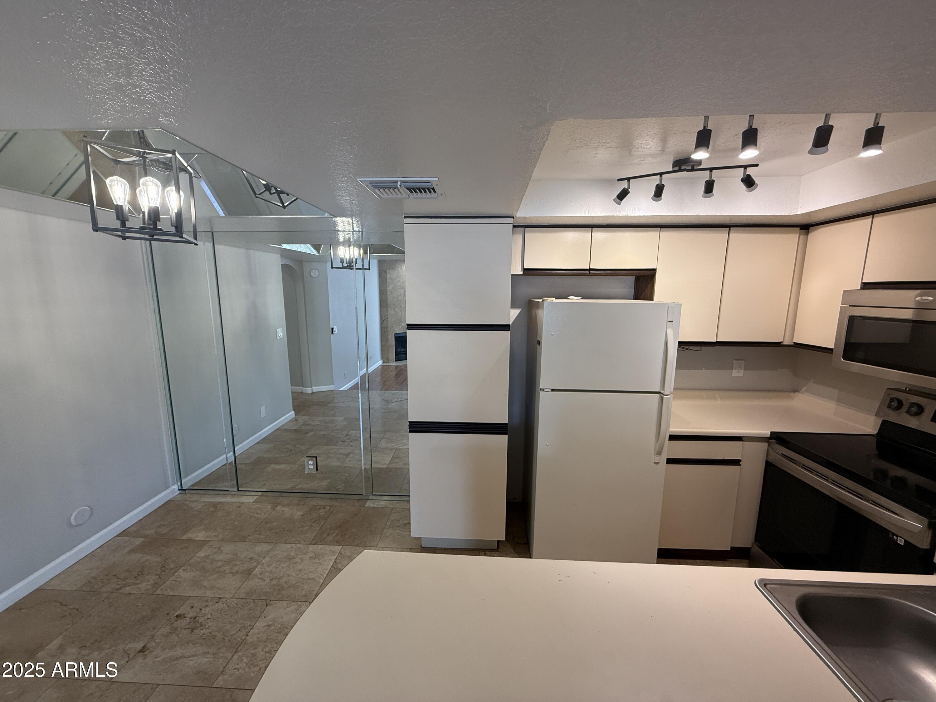 1820 East Morten Avenue, Unit 125 Phoenix, AZ 85020 - Photo 12 of 21 a kitchen with stainless steel appliances a refrigerator and a sink
