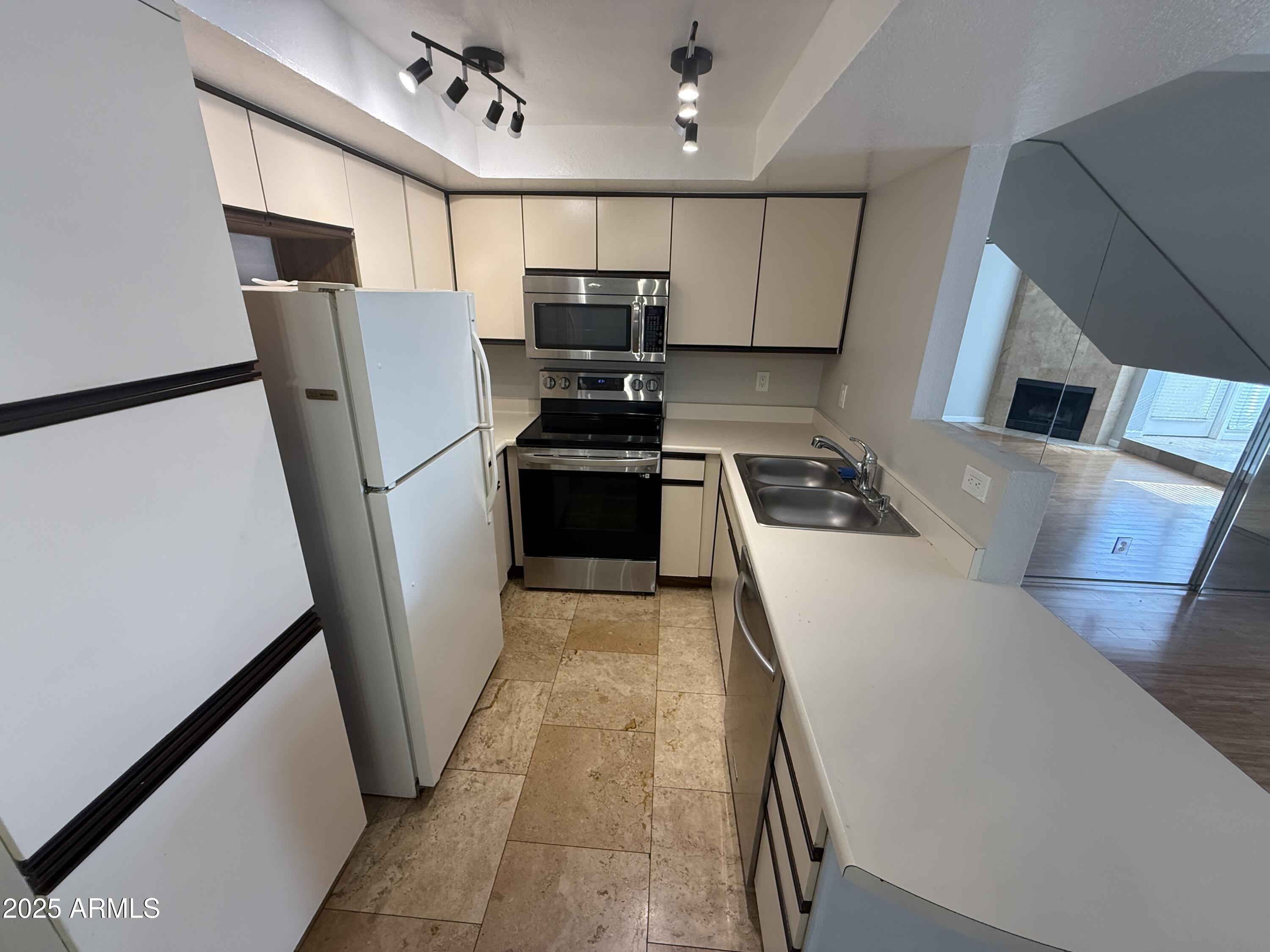 1820 East Morten Avenue, Unit 125 Phoenix, AZ 85020 - Photo 13 of 21 a kitchen with stainless steel appliances a refrigerator a sink a stove top oven a refrigerator and dishwasher
