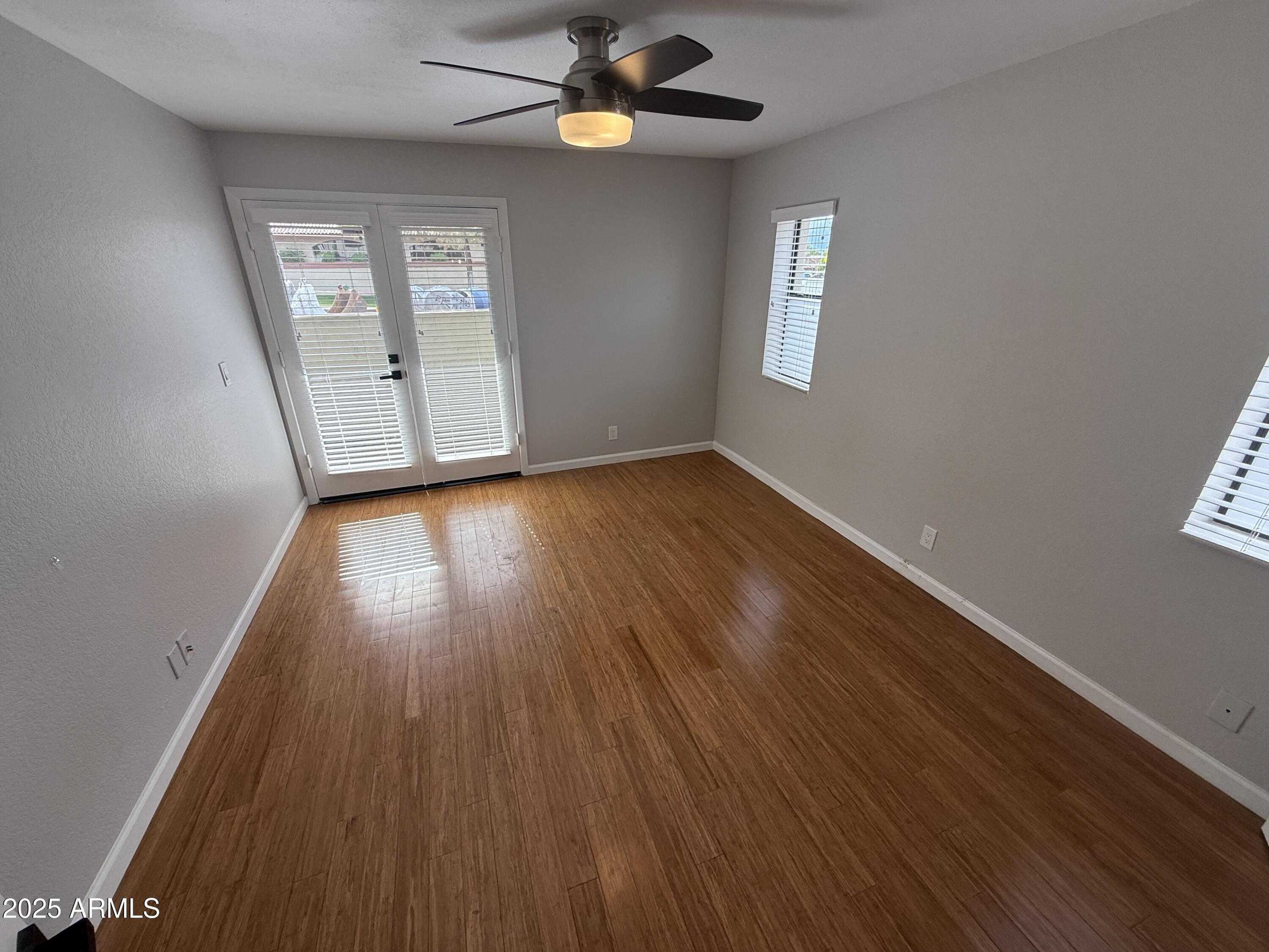 1820 East Morten Avenue, Unit 125 Phoenix, AZ 85020 - Photo 15 of 21 a view of an empty room with wooden floor and a window