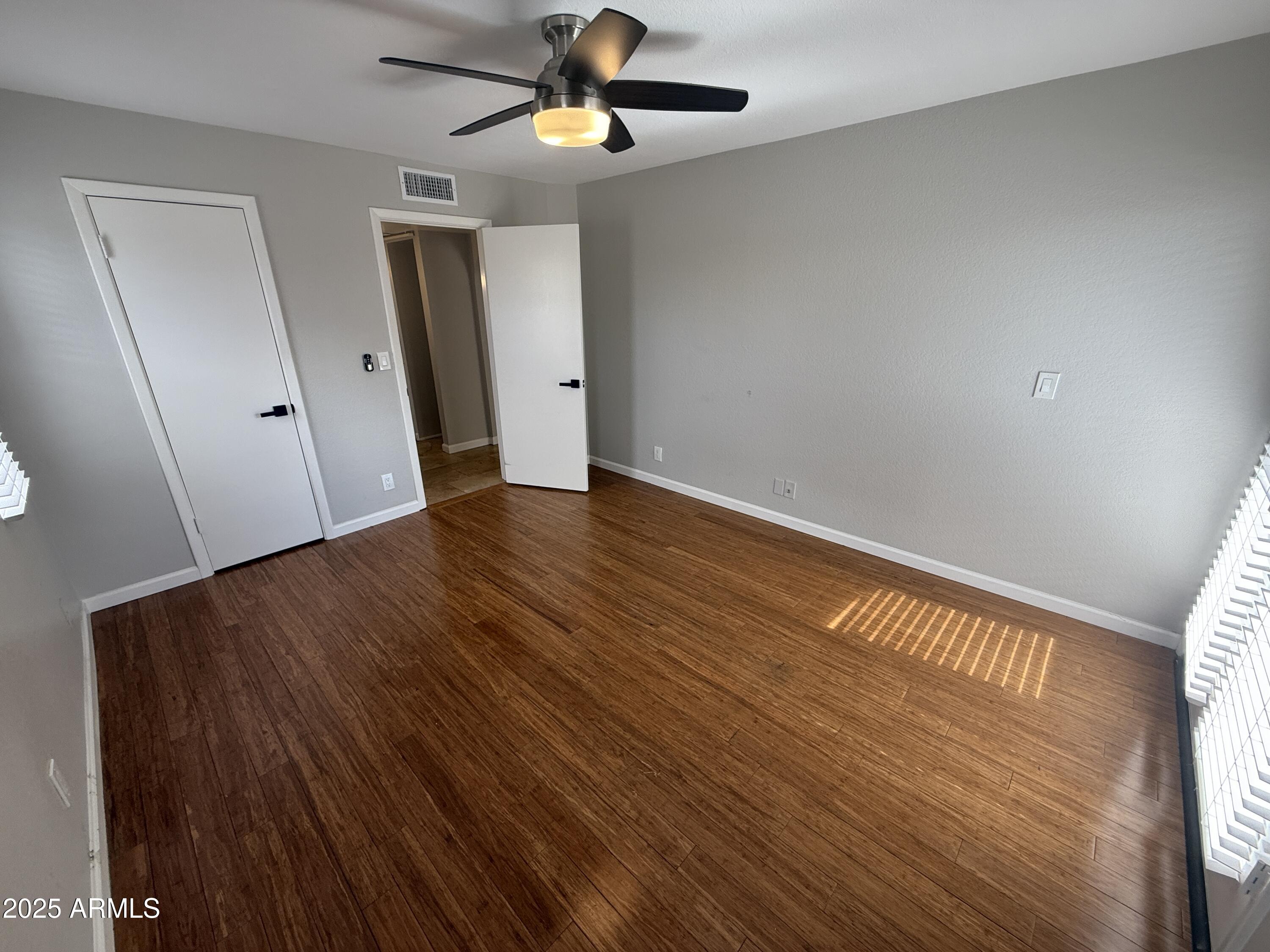 1820 East Morten Avenue, Unit 125 Phoenix, AZ 85020 - Photo 16 of 21 wooden floor in an empty room with a window