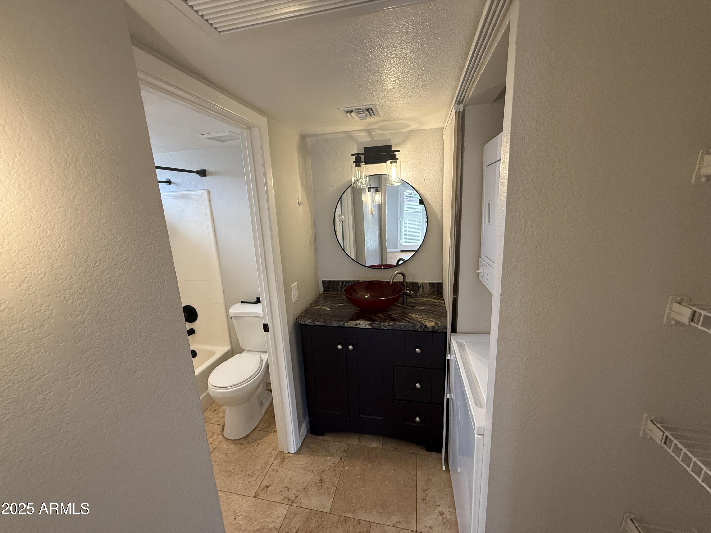 1820 East Morten Avenue, Unit 125 Phoenix, AZ 85020 - Photo 18 of 21 a bathroom with a toilet mirror and vanity