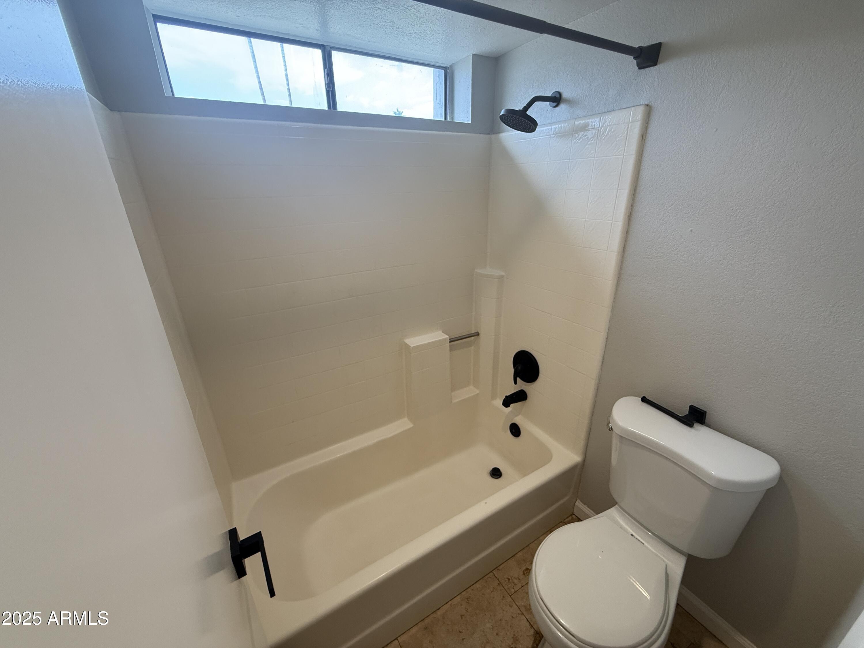 1820 East Morten Avenue, Unit 125 Phoenix, AZ 85020 - Photo 20 of 21 a white toilet sitting next to a bath tub