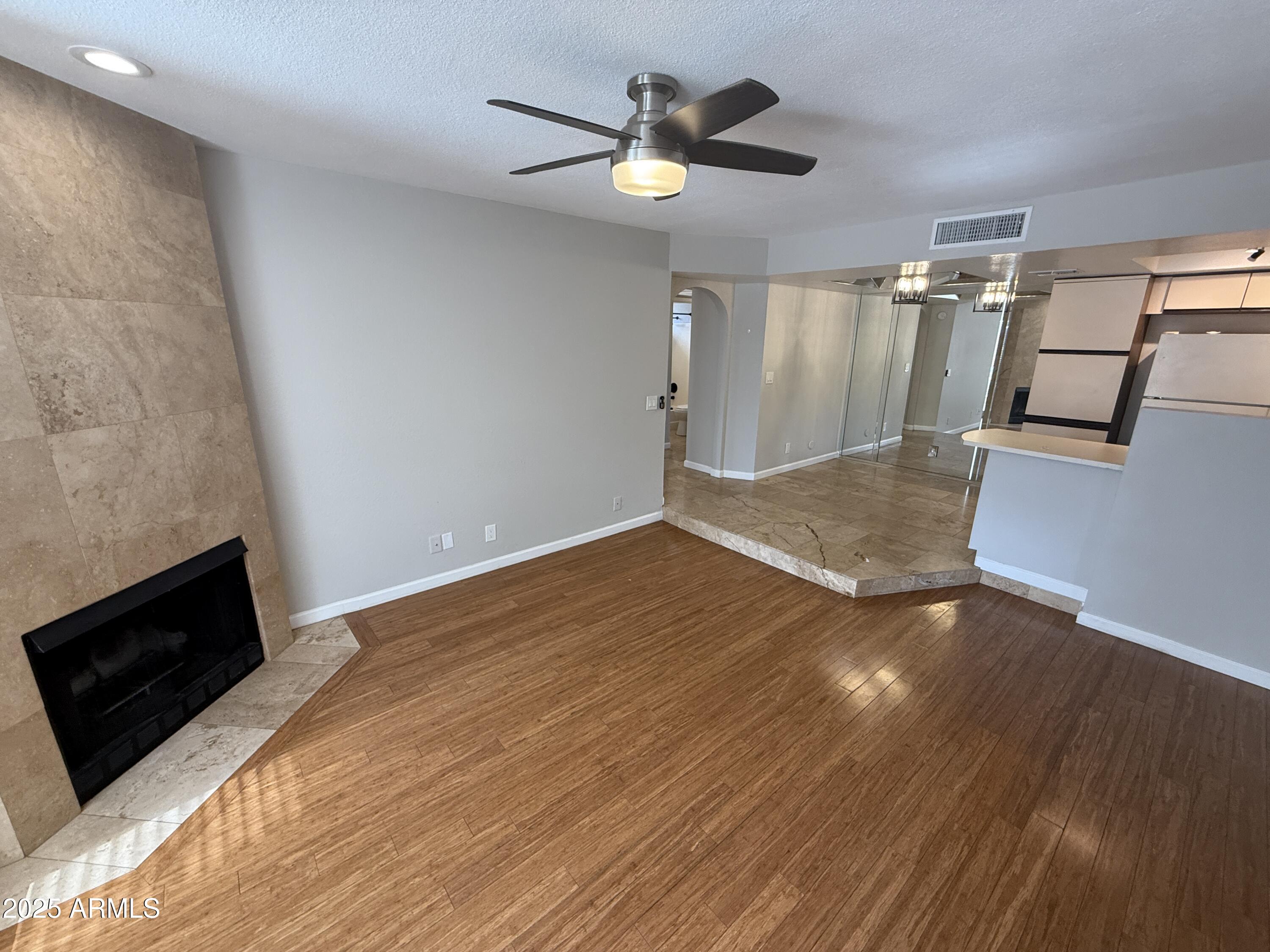 1820 East Morten Avenue, Unit 125 Phoenix, AZ 85020 - Photo 7 of 21 wooden floor in an empty room with a fireplace