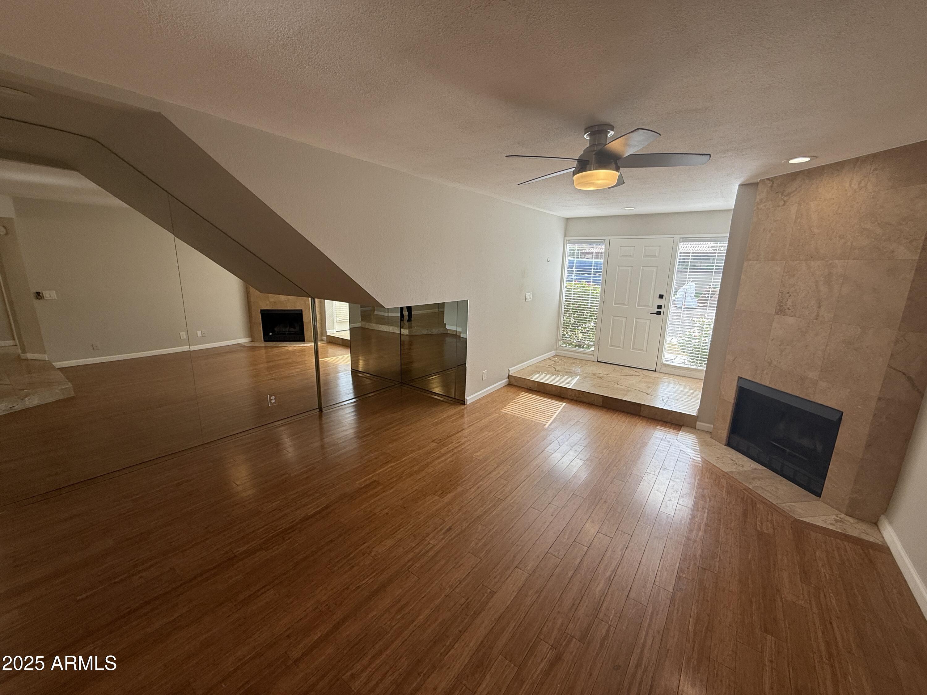 1820 East Morten Avenue, Unit 125 Phoenix, AZ 85020 - Photo 8 of 21 a view of a livingroom with wooden floor and a ceiling fan