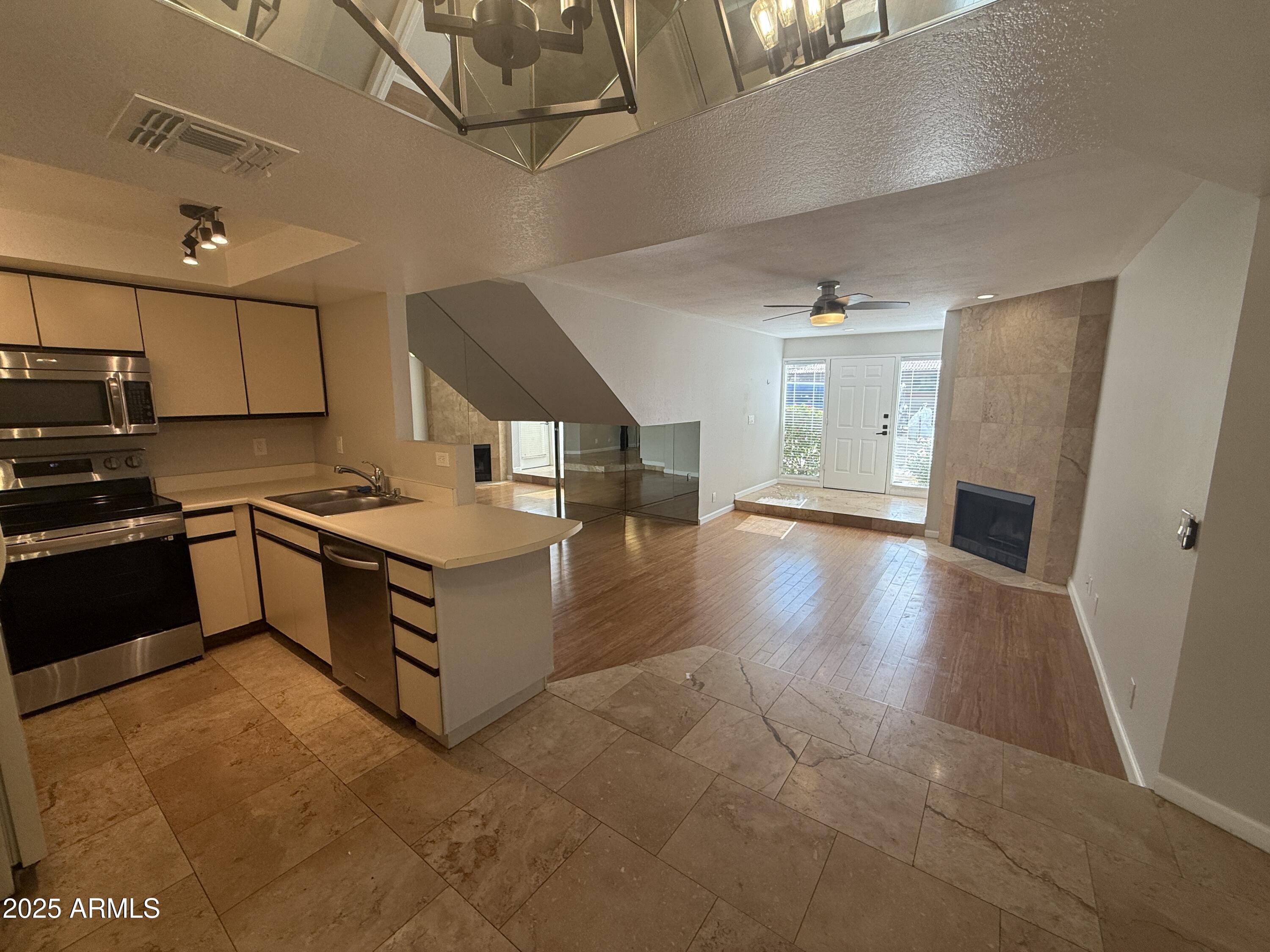 1820 East Morten Avenue, Unit 125 Phoenix, AZ 85020 - Photo 10 of 21 a kitchen with stainless steel appliances a stove a sink and a refrigerator