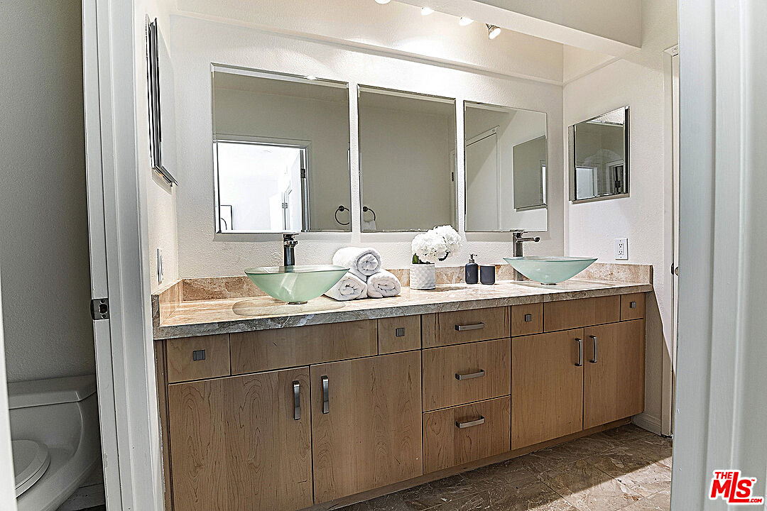 2041 Roscomare Road Los Angeles, CA 90077 - Photo 12 of 28 a bathroom with a granite countertop sink and a mirror