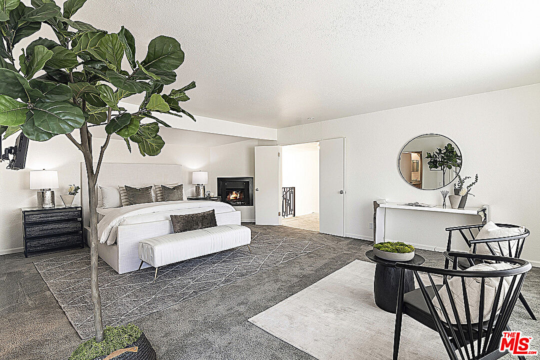 2041 Roscomare Road Los Angeles, CA 90077 - Photo 14 of 28 a living room with furniture a chandelier and a potted plant