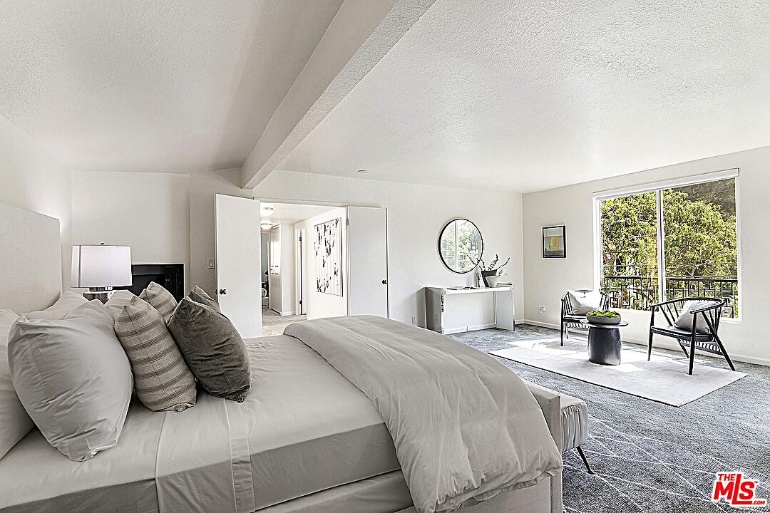 2041 Roscomare Road Los Angeles, CA 90077 - Photo 15 of 28 a bedroom with a large bed a large window and flat screen tv