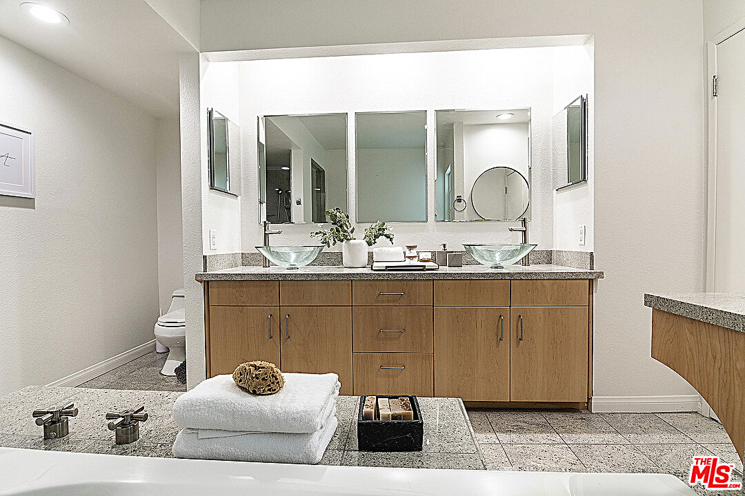 2041 Roscomare Road Los Angeles, CA 90077 - Photo 17 of 28 a bathroom with a sink and a mirror