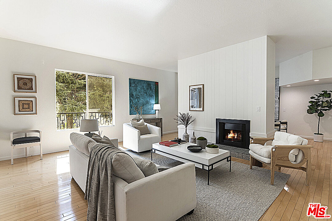 2041 Roscomare Road Los Angeles, CA 90077 - Photo 3 of 28 a living room with furniture and a fireplace