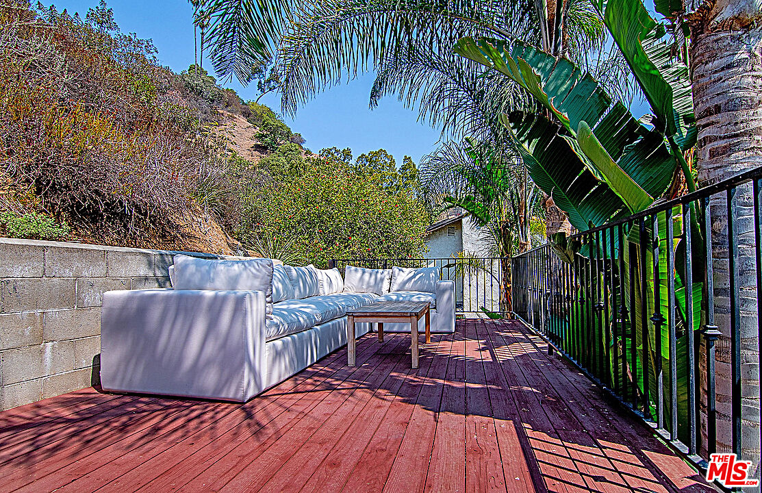 2041 Roscomare Road Los Angeles, CA 90077 - Photo 26 of 28 a view of a backyard with a deck and wooden floor