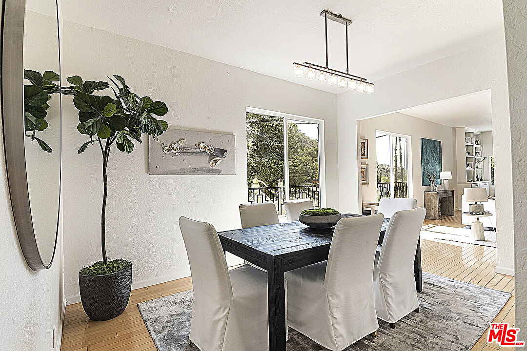 2041 Roscomare Road Los Angeles, CA 90077 - Photo 5 of 28 a dining room with furniture potted plants and wooden floor