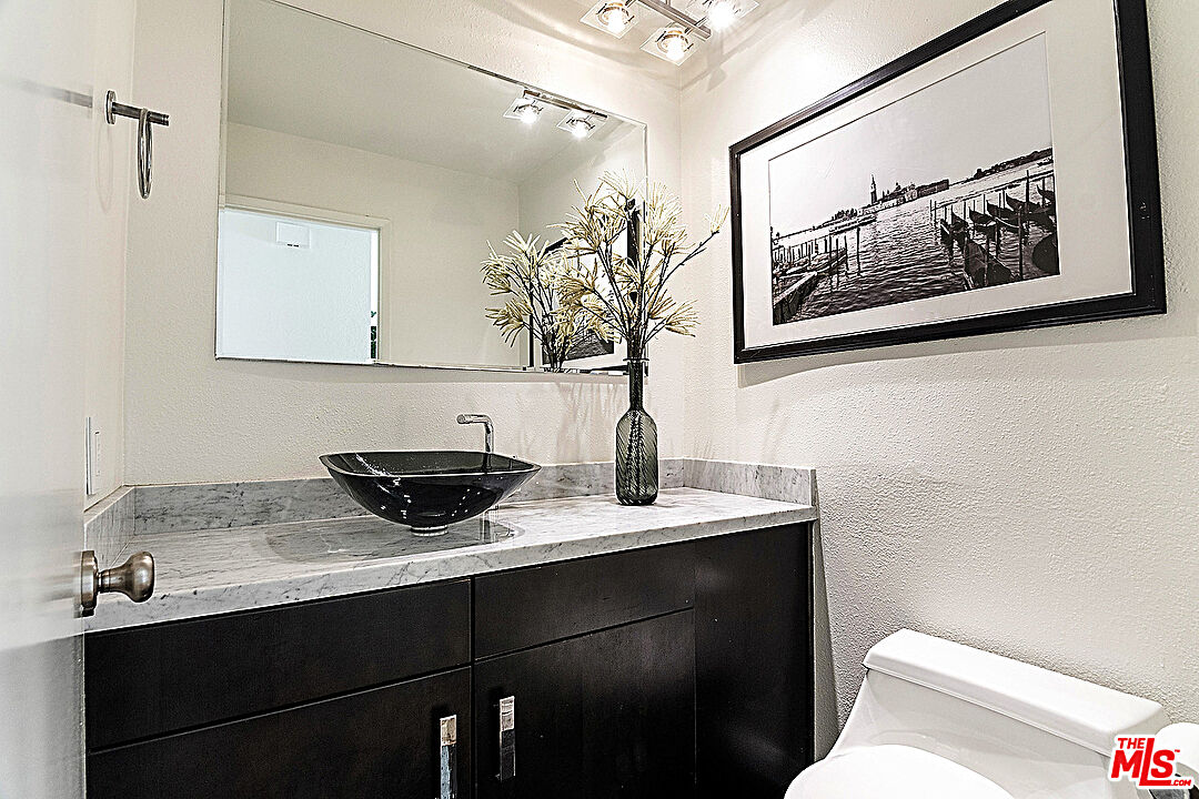 2041 Roscomare Road Los Angeles, CA 90077 - Photo 8 of 28 a bathroom with a sink and a toilet