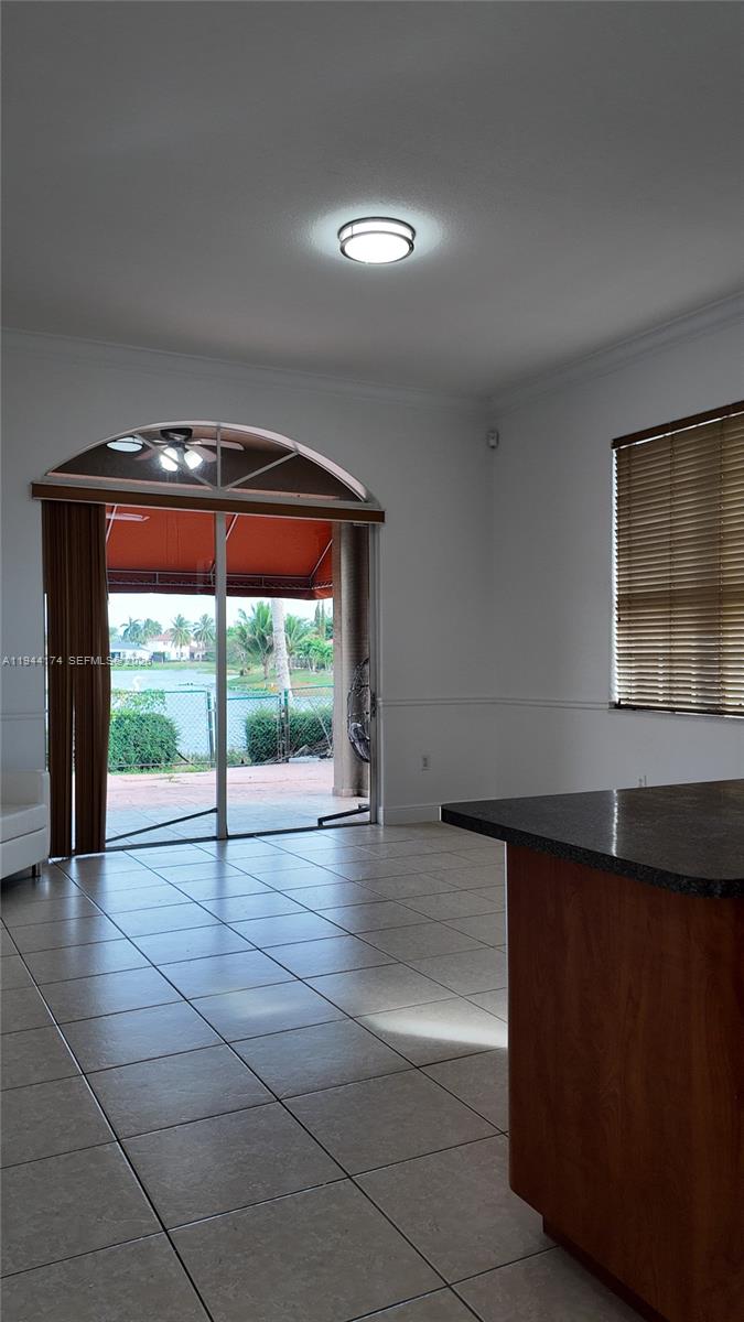 3265 Southwest 153rd Place Miami, FL 33185 - Photo 14 of 39 a view of empty room with wooden floor and fan