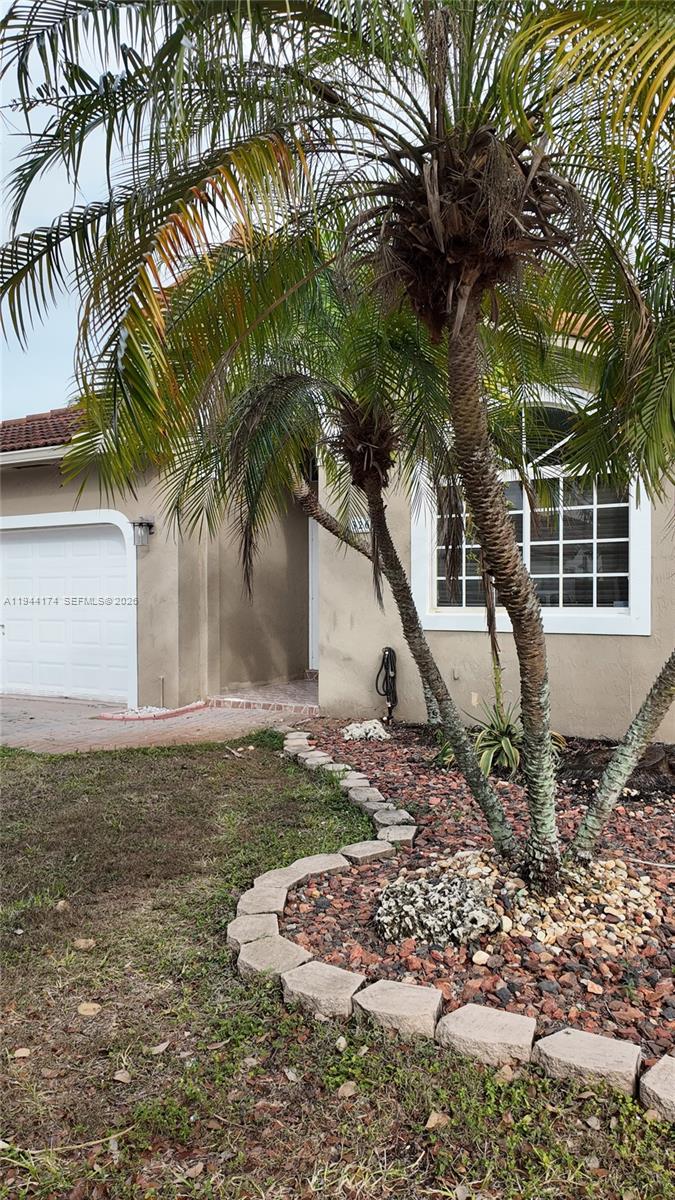 3265 Southwest 153rd Place Miami, FL 33185 - Photo 2 of 39 a backyard of a house with lots of green space