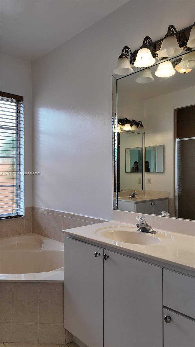 3265 Southwest 153rd Place Miami, FL 33185 - Photo 24 of 39 a bathroom with a sink and a mirror