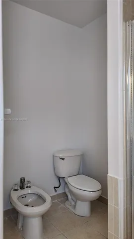 a white toilet sitting next to a bathroom sink