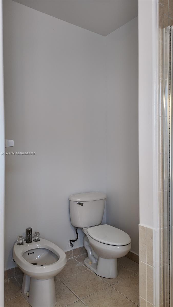 3265 Southwest 153rd Place Miami, FL 33185 - Photo 28 of 39 a white toilet sitting next to a bathroom sink
