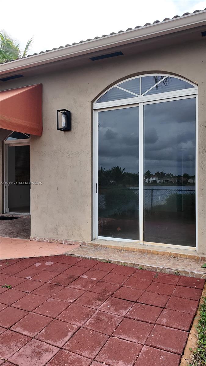 3265 Southwest 153rd Place Miami, FL 33185 - Photo 32 of 39 a front view of a house with a yard