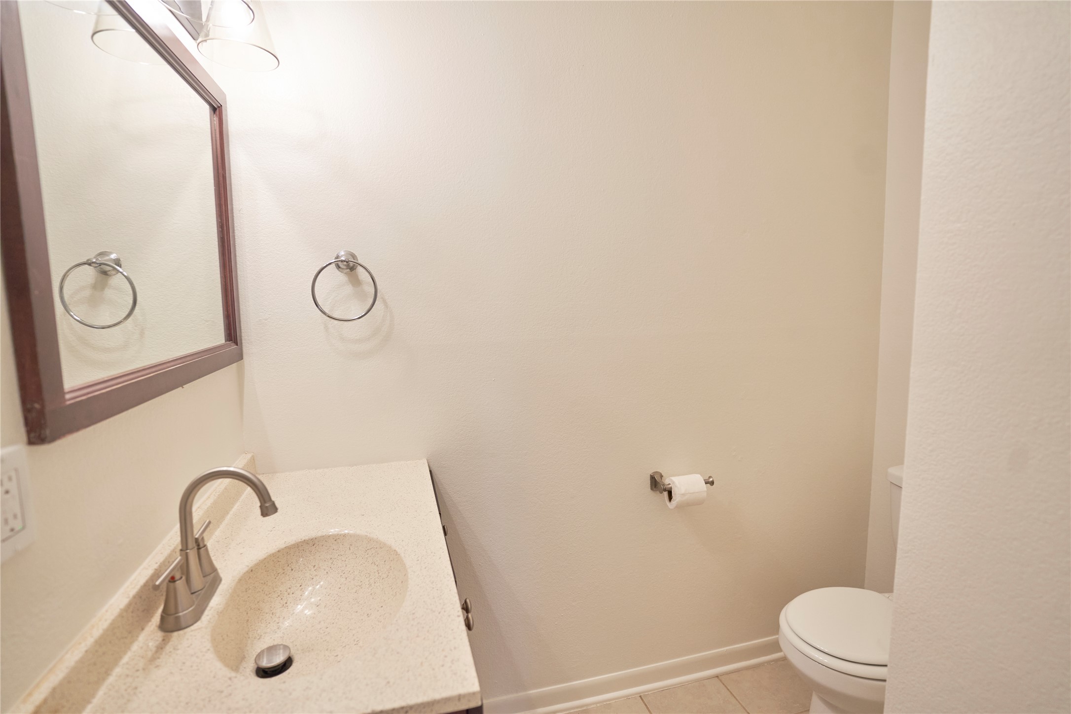 23393 Nameless Road, Unit 171 Leander, TX 78641 - Photo 6 of 15 A compact and functional bathroom offering a vanity with a sleek faucet and a practical toilet setup.