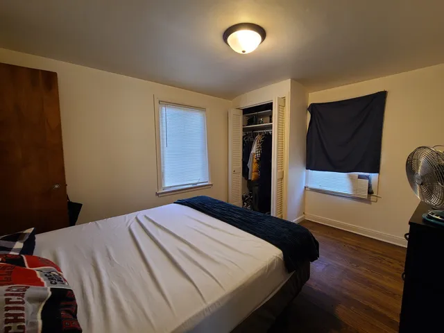 a bedroom with a bed and a large mirror
