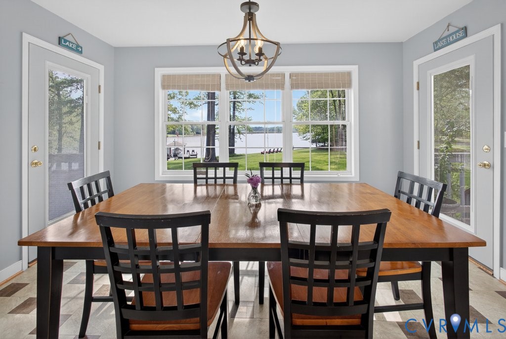 173 Covenant Way Bumpass, VA 23024 - Photo 12 of 63 Dining area featuring a large window with a lake v