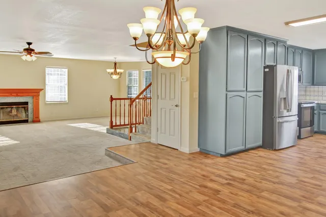 a kitchen with stainless steel appliances granite countertop a sink a stove and wooden cabinets