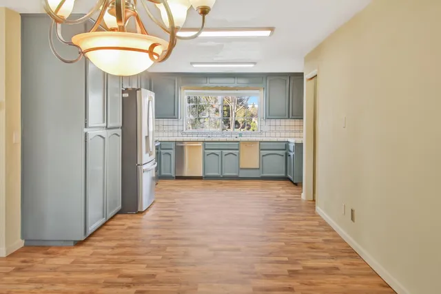 a kitchen with stainless steel appliances granite countertop a sink and a window
