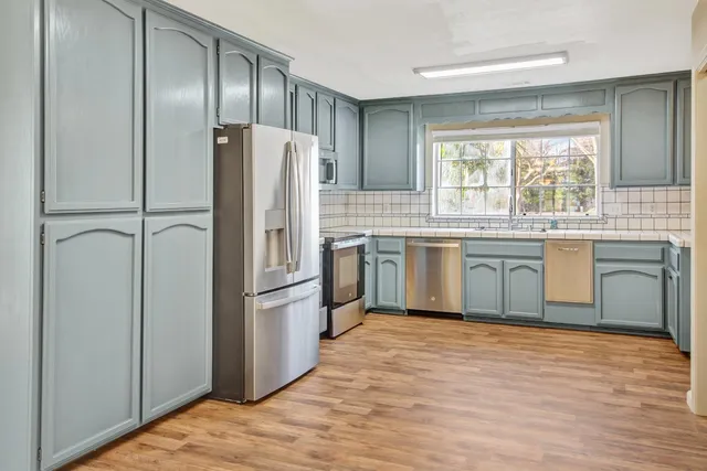 a kitchen with cabinets and appliances