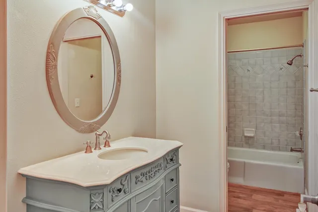 a living room with hard wood floors and a ceiling fan