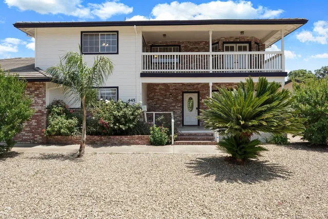 a view of an empty room with a fireplace and a window