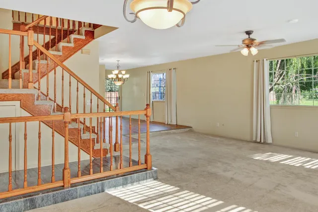 a view of a room with wooden floor windows and entryway