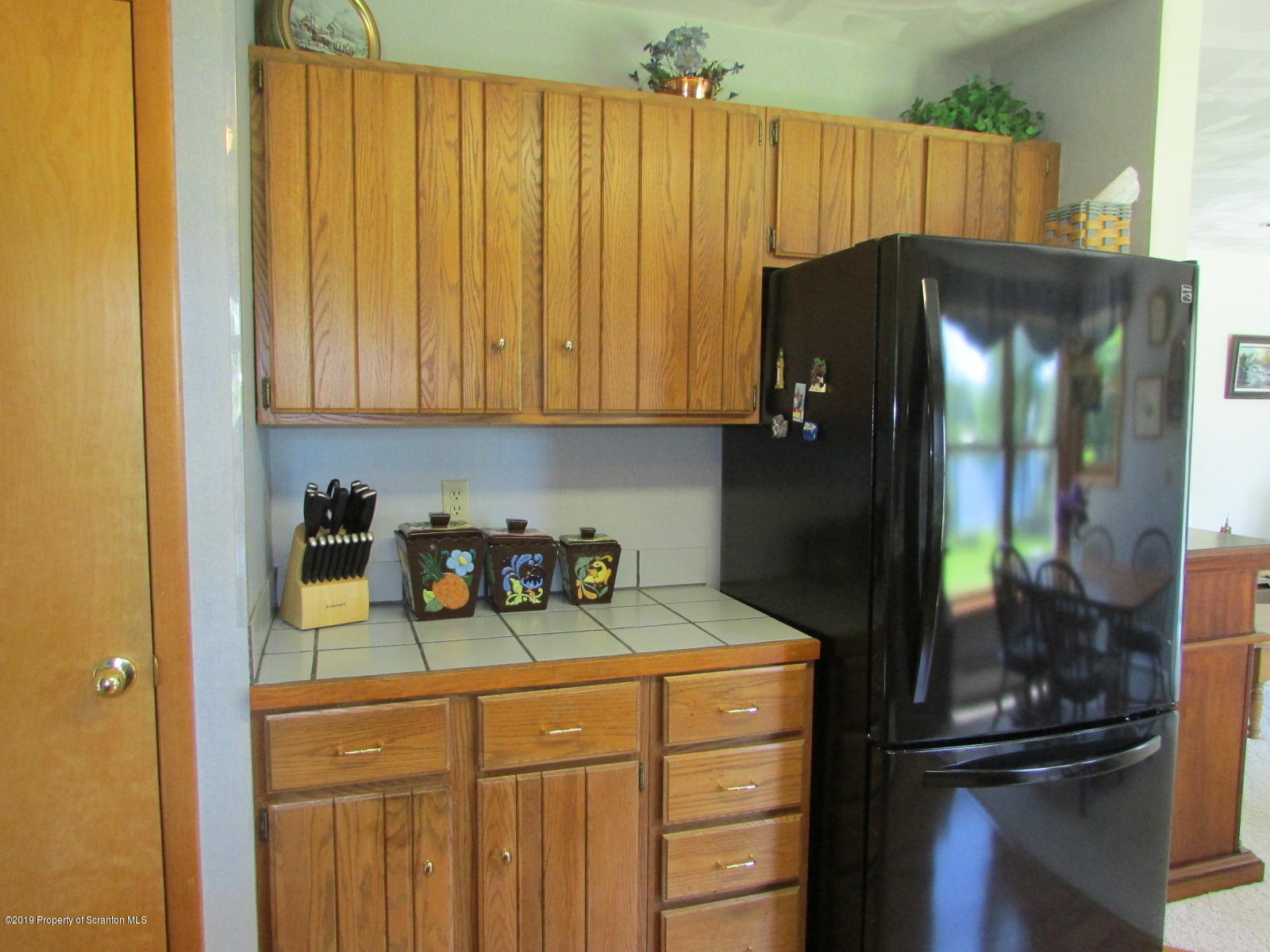 1315 Old County Road Montrose, PA 18801 - Photo 12 of 74 a kitchen with a refrigerator and cabinets