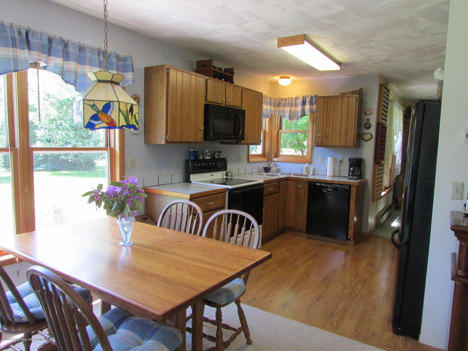 1315 Old County Road Montrose, PA 18801 - Photo 14 of 74 a kitchen with sink refrigerator dining table and chairs