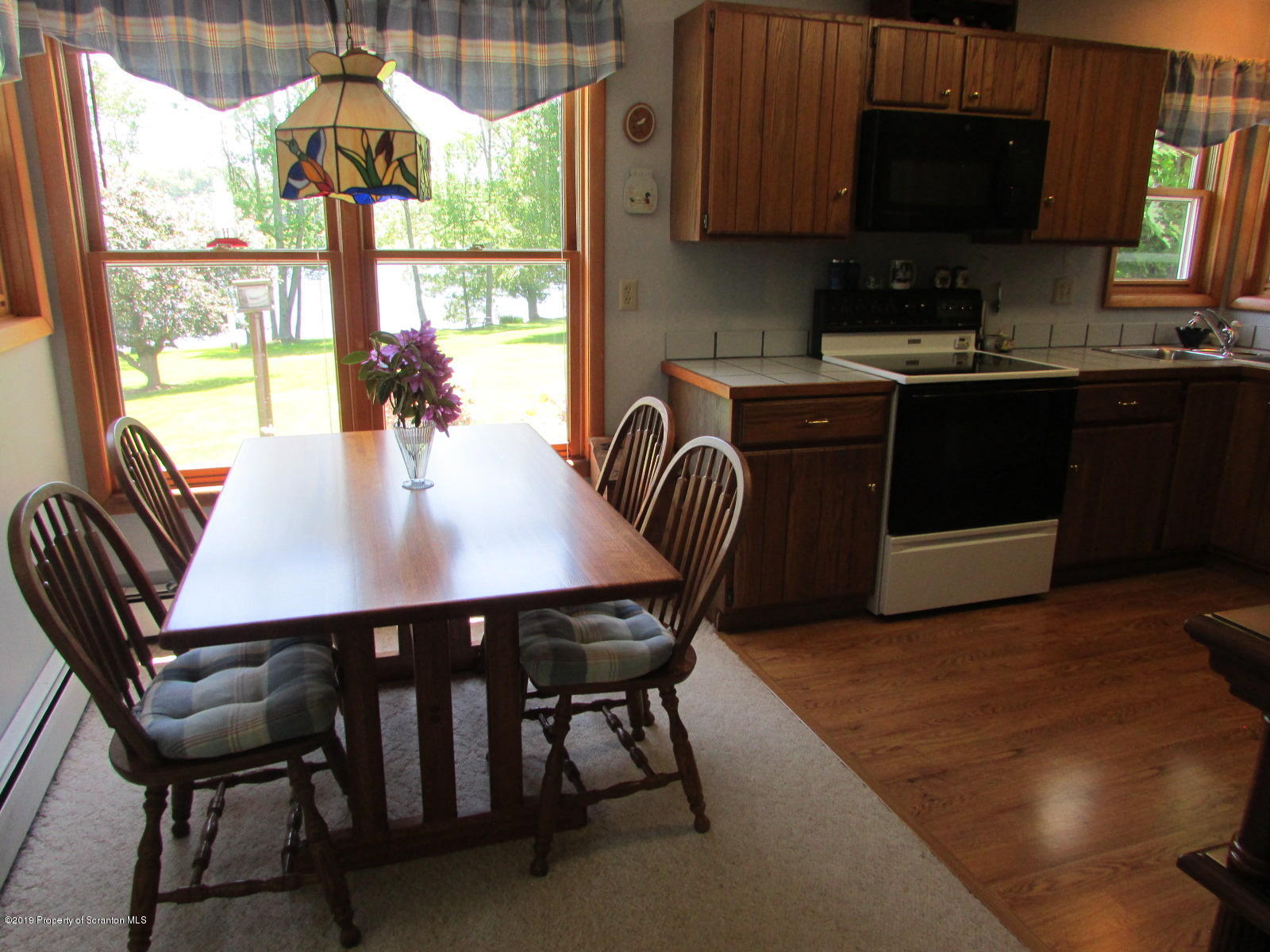 1315 Old County Road Montrose, PA 18801 - Photo 15 of 74 a kitchen with a wooden table chairs and granite counter tops