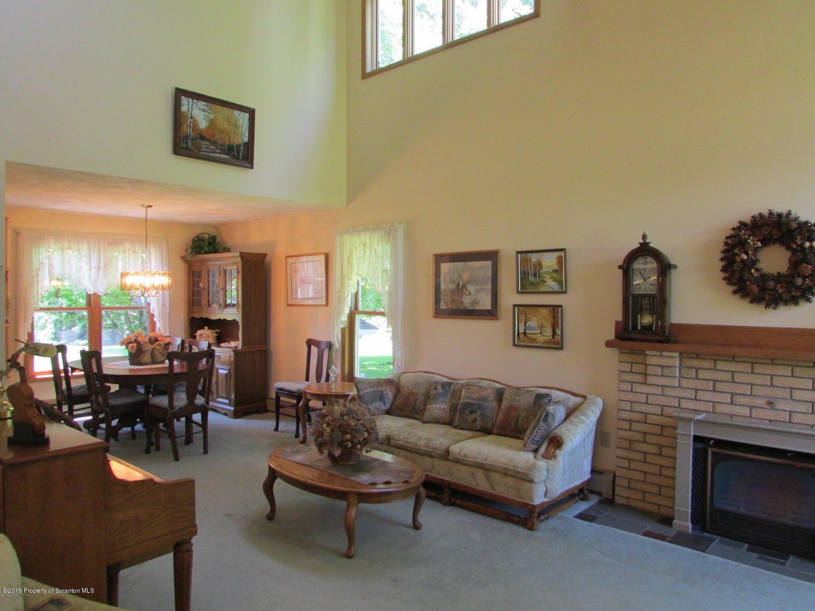 1315 Old County Road Montrose, PA 18801 - Photo 24 of 74 a living room with furniture a fireplace and a large mirror
